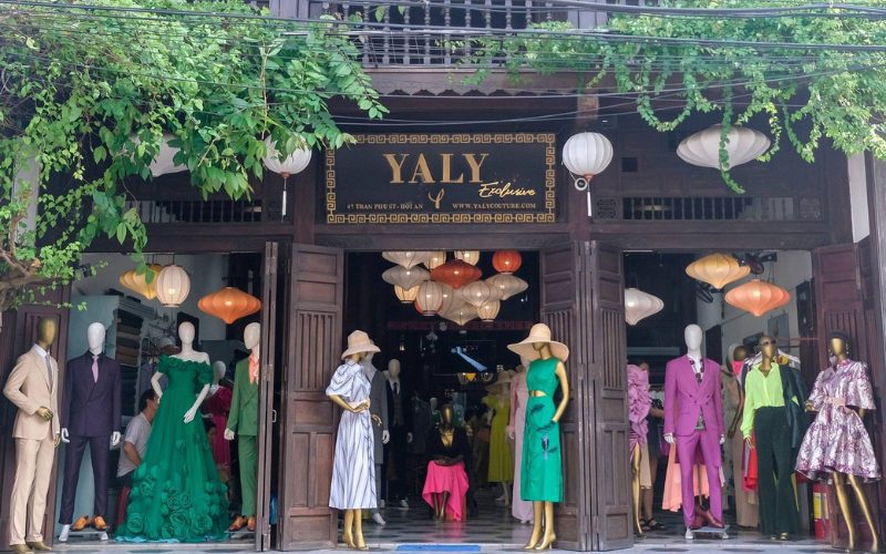 Façade de la boutique de couture Yaly à Hoi An, avec des mannequins exposant des vêtements élégants sur mesure