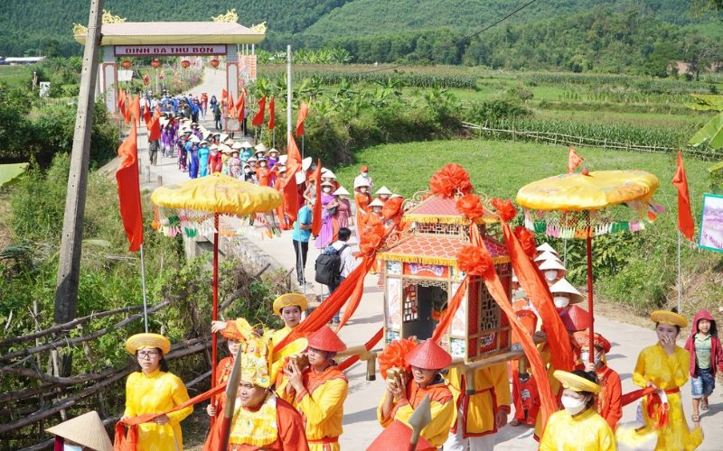 Procession traditionnelle lors du festival de Dame Thu Bon au Vietnam, avec des participants vêtus de tenues colorées